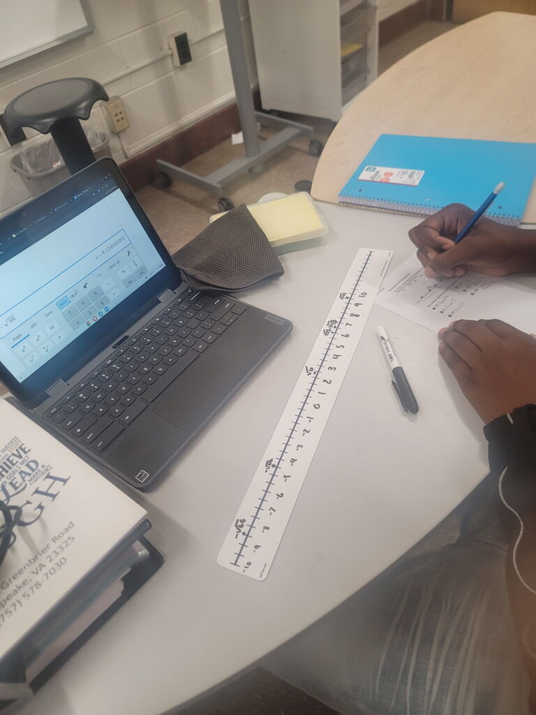 8th grade math students using dry erase tables to work on math problems