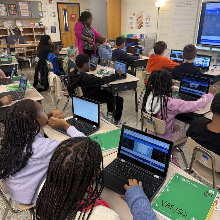 students on Chromebooks researching planets.