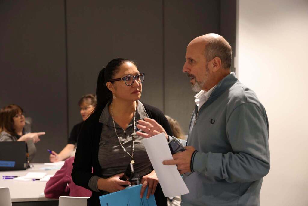 An employee and benefits specialist speaking together about benefit options.