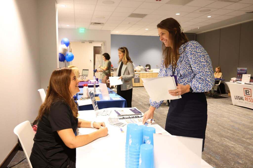 Employee speaking with a benefits provider at the Open Enrollment Fair.