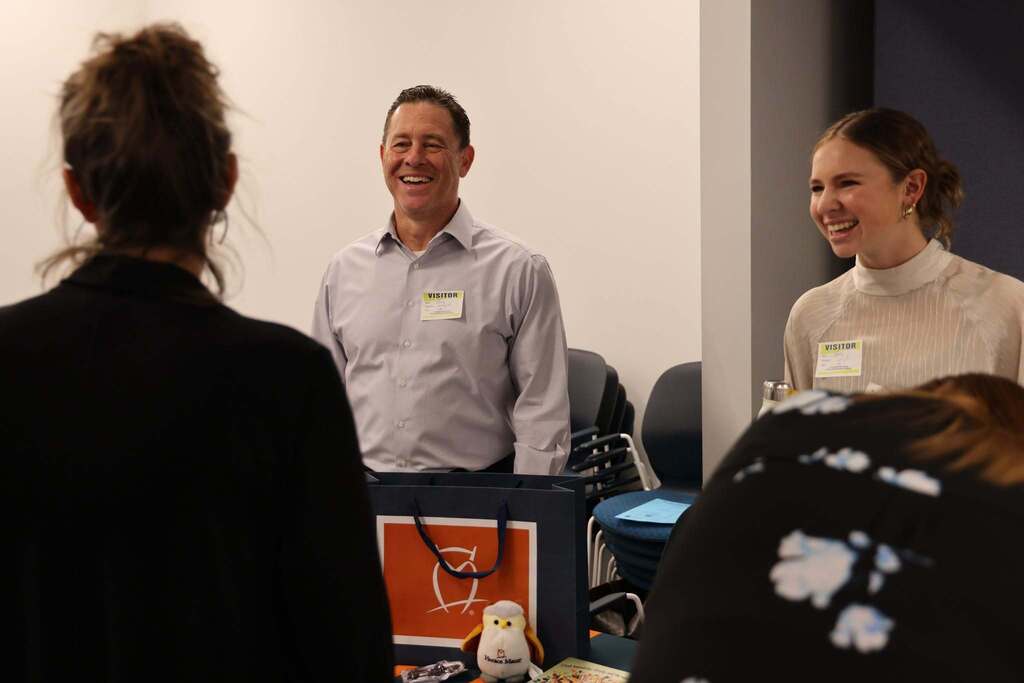 Benefits providers and employee smiling and lauging together.