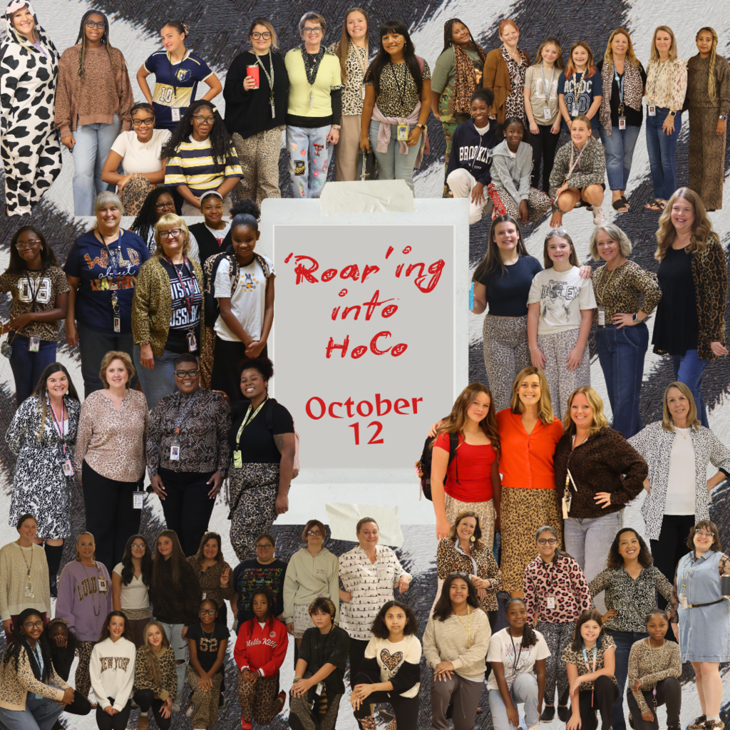 A photo collage of enthusiastic students and staff dressed in animal print patterns and costumes against a zebra-striped background. A white taped note in the center reads "'Roar'ing into HoCo October 12". The image conveys a fun, energetic, and unified school spirit