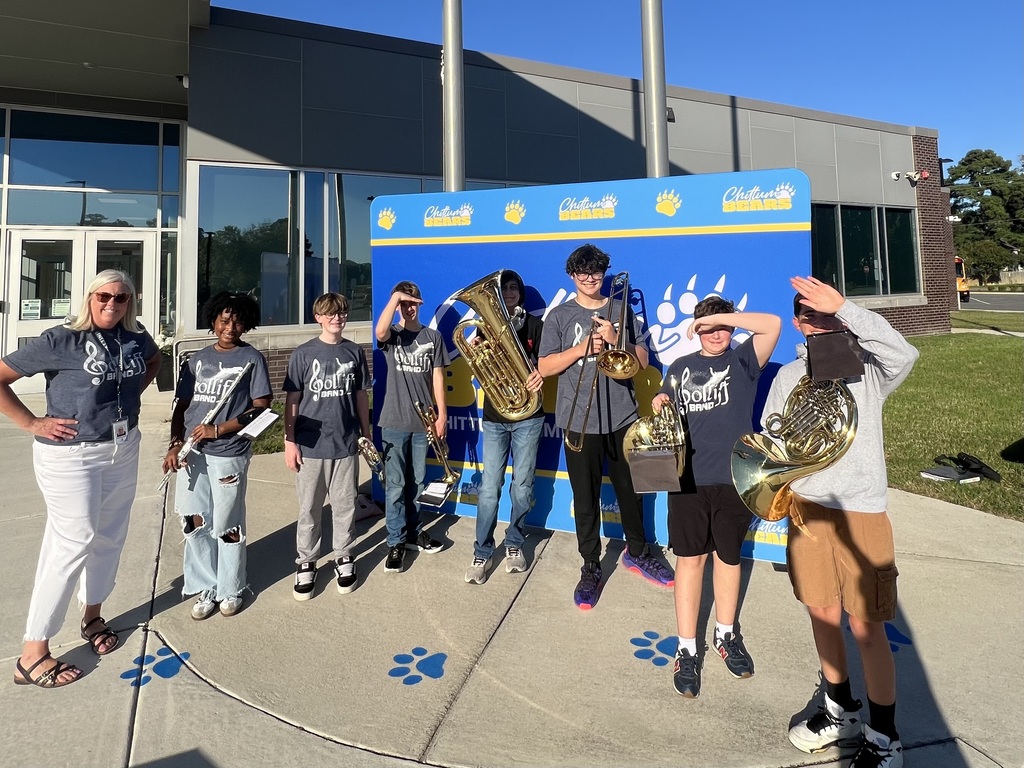 8th grade band members and Ms. Rossettini at Chittum Elementary, there to play for the student's pep rally.