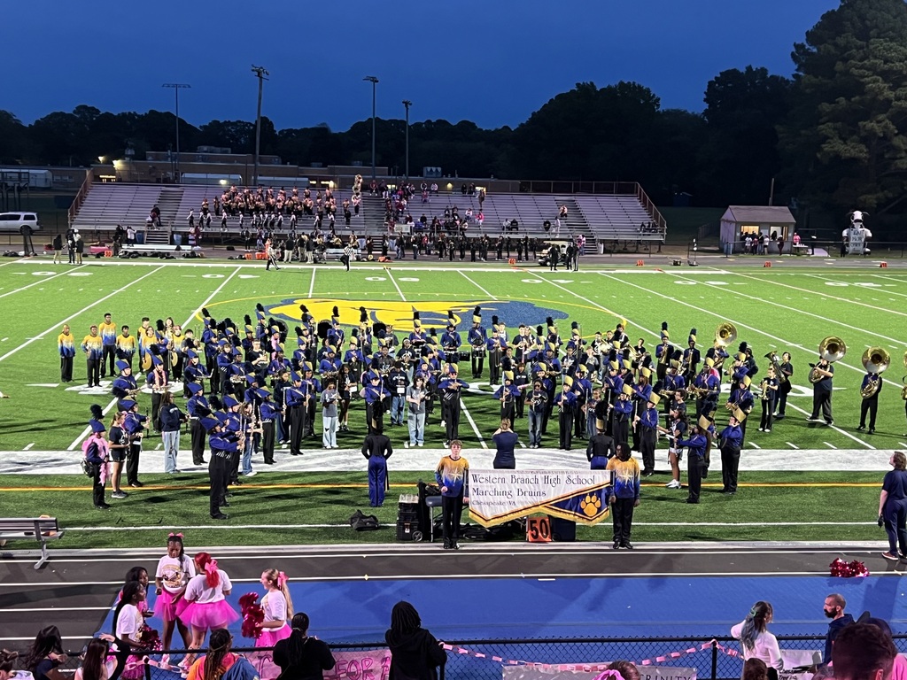 Western Branch High School Marching Band with member of the Jolliff Middle band performing together at a Friday night football game