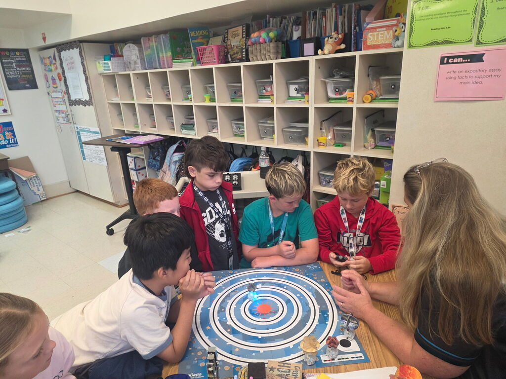 students using ozobots to review planets 