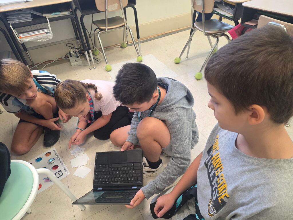 students using ozobots to review planets 