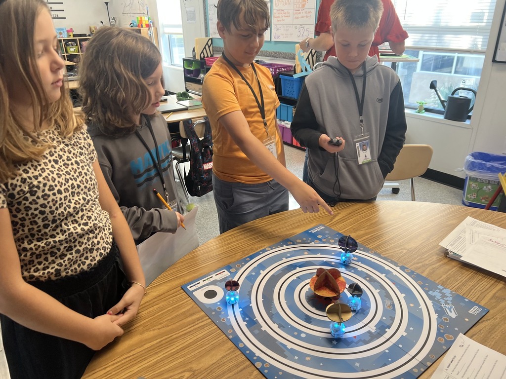 students using ozobots to review planets 
