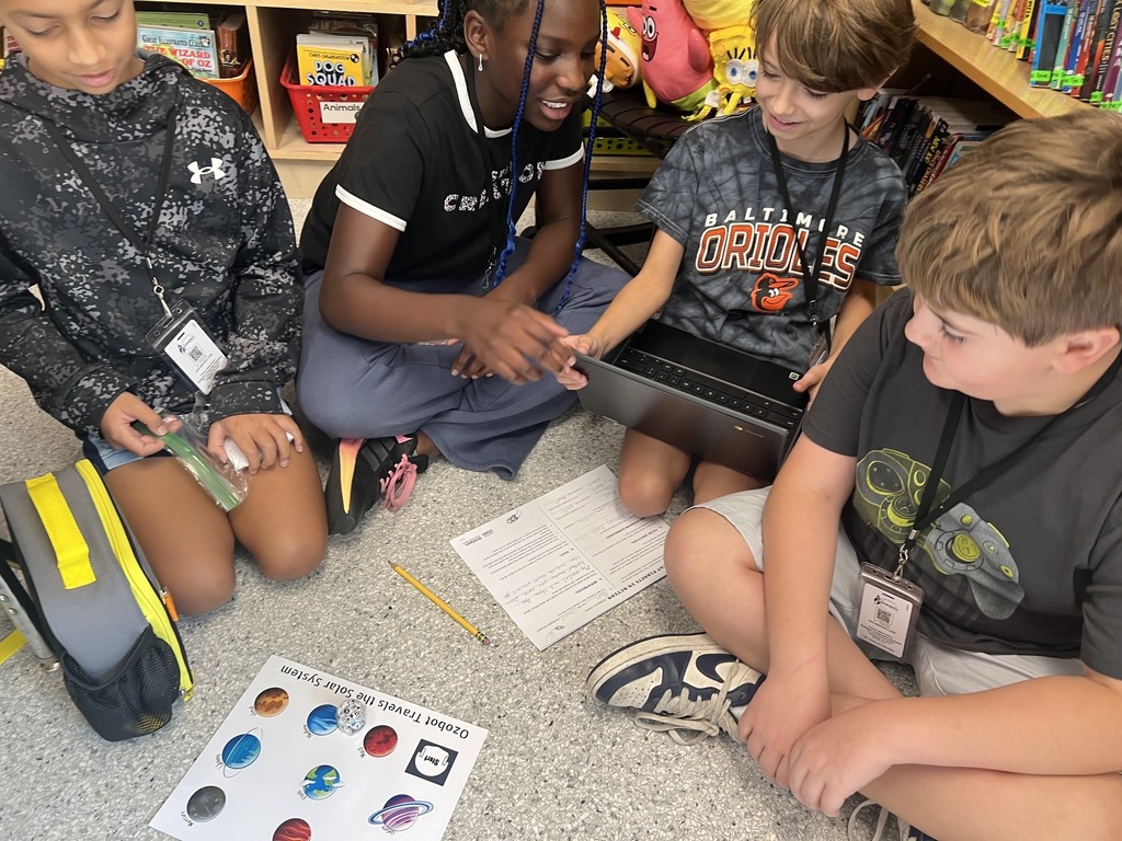 students using ozobots to review planets 