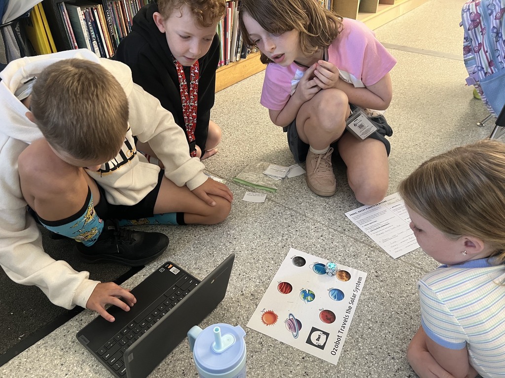 students using ozobots to review planets 