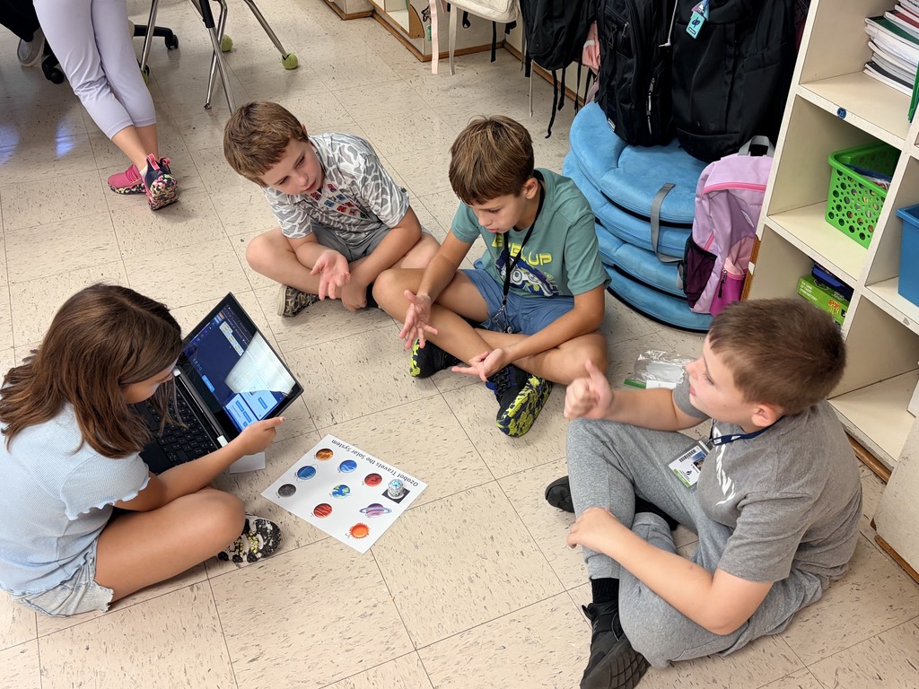 students using ozobots to review planets 