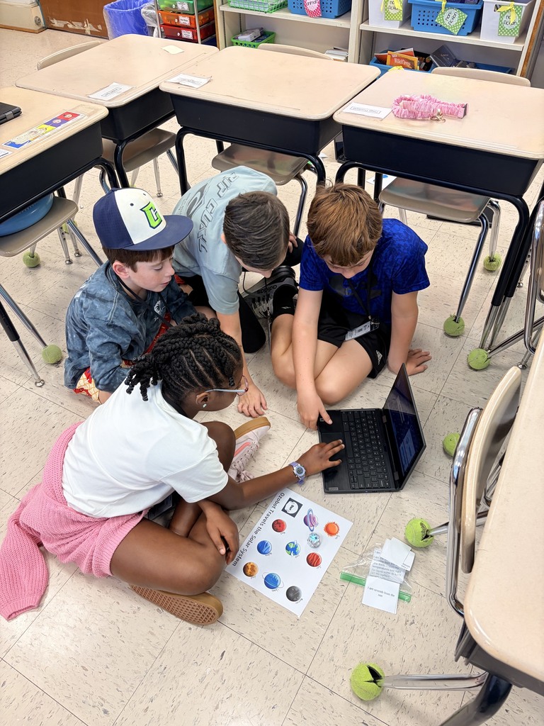 students using ozobots to review planets 
