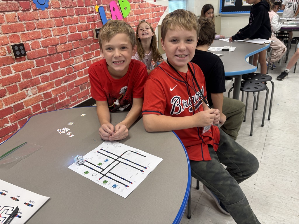 BRI students work with ozobots to trick-r-treat around a neighborhood collecting candy.