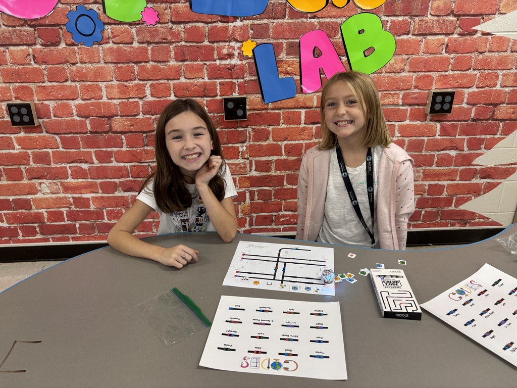 BRI students work with ozobots to trick-r-treat around a neighborhood collecting candy.