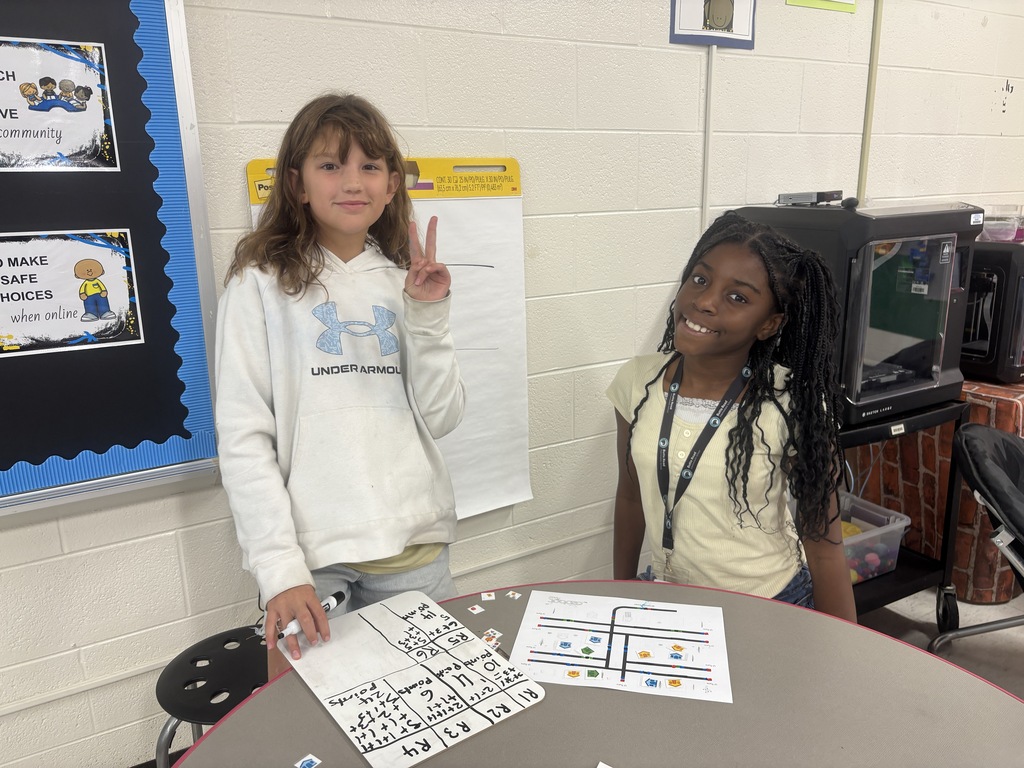 BRI students work with ozobots to trick-r-treat around a neighborhood collecting candy.
