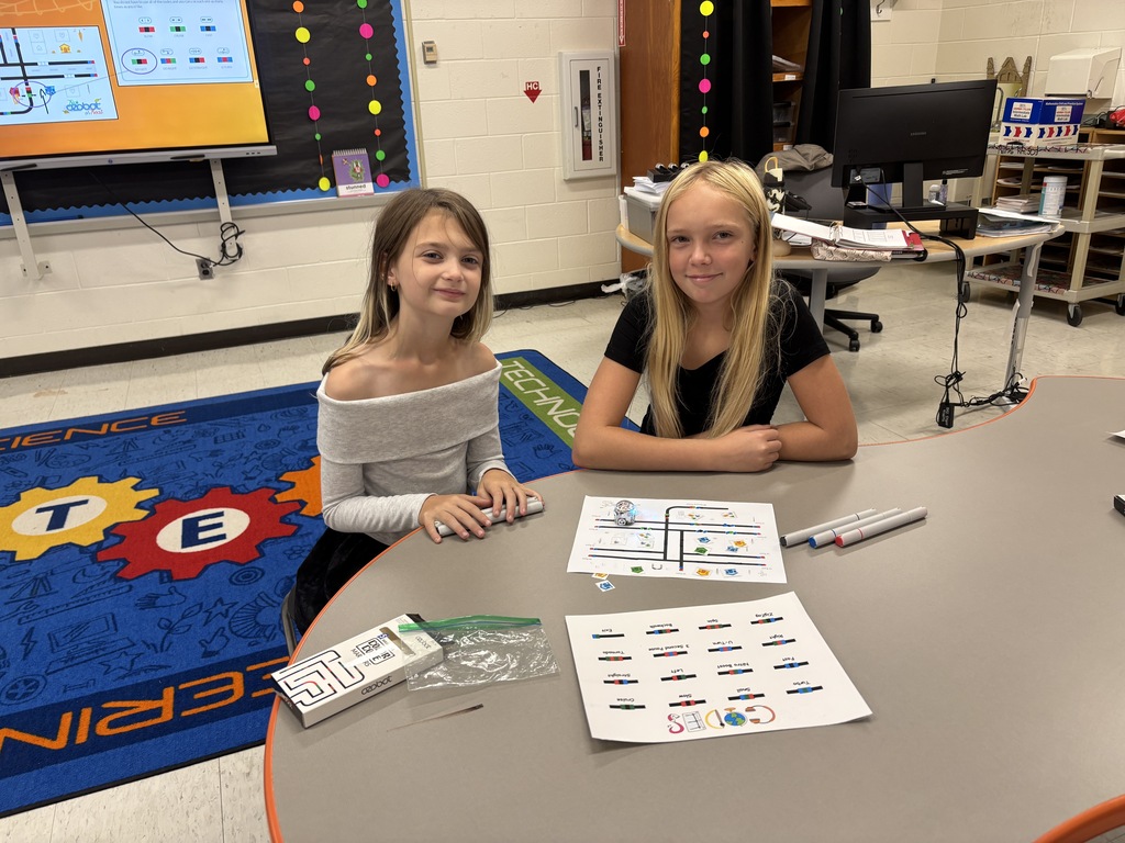 BRI students work with ozobots to trick-r-treat around a neighborhood collecting candy.