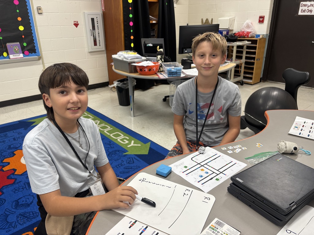 BRI students work with ozobots to trick-r-treat around a neighborhood collecting candy.