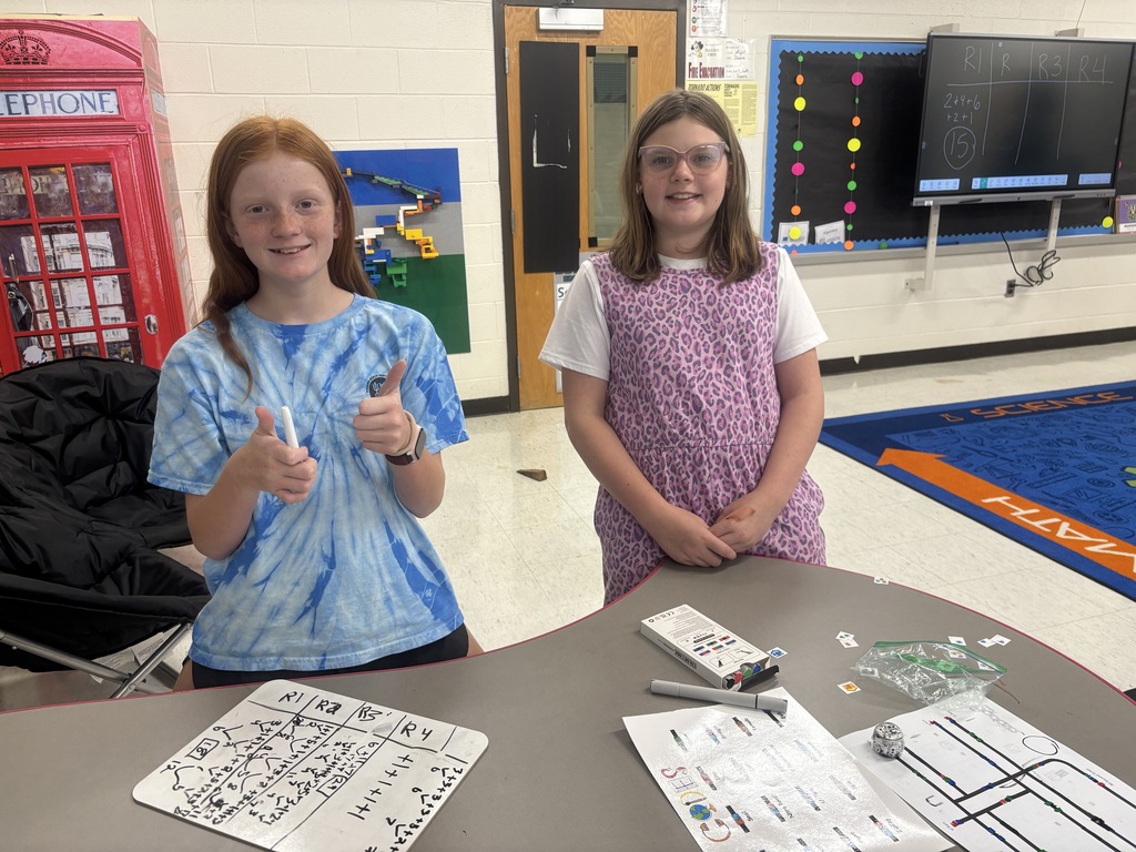 BRI students work with ozobots to trick-r-treat around a neighborhood collecting candy.