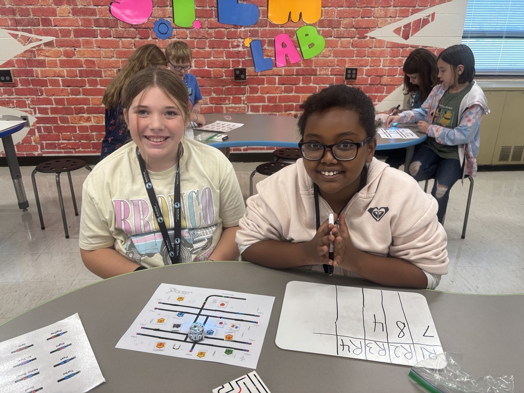 BRI students work with ozobots to trick-r-treat around a neighborhood collecting candy.