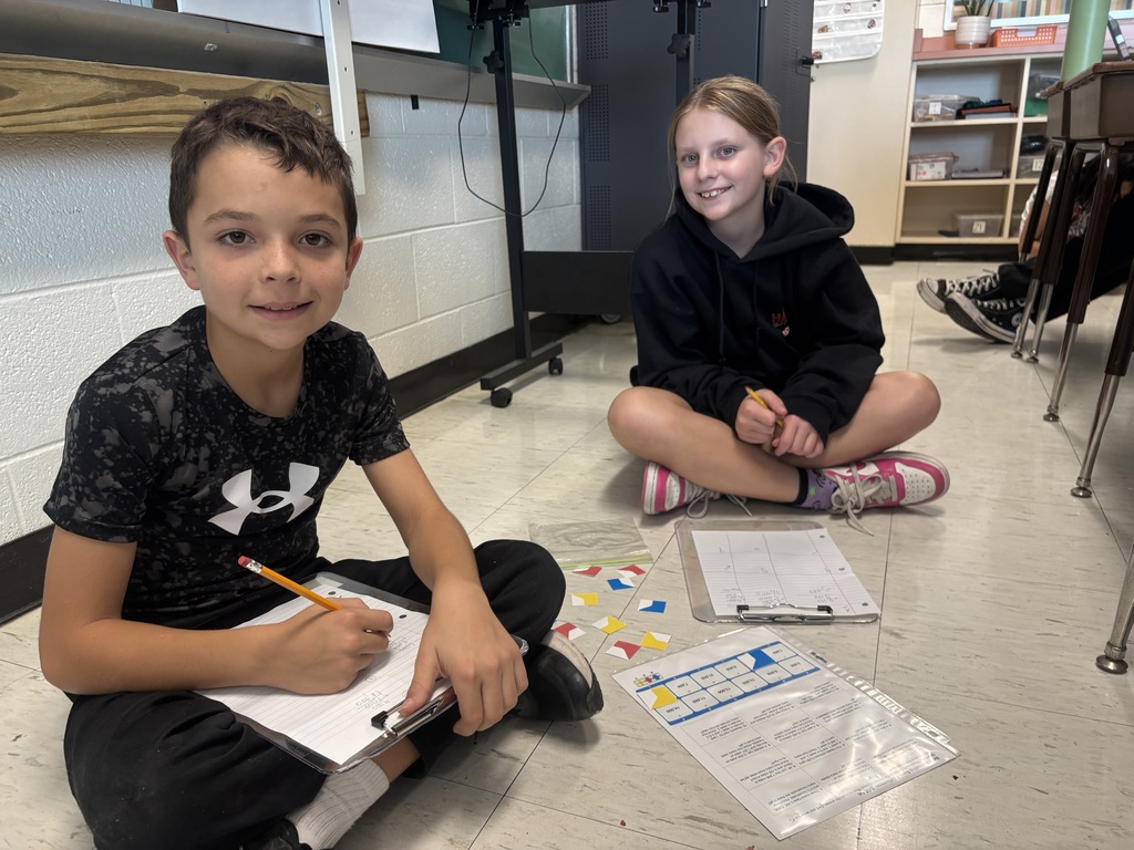 alt text for photos Students in Ms. McCoy’s class use Versa-Tiles puzzles to solve story problems and practice estimation and computation.