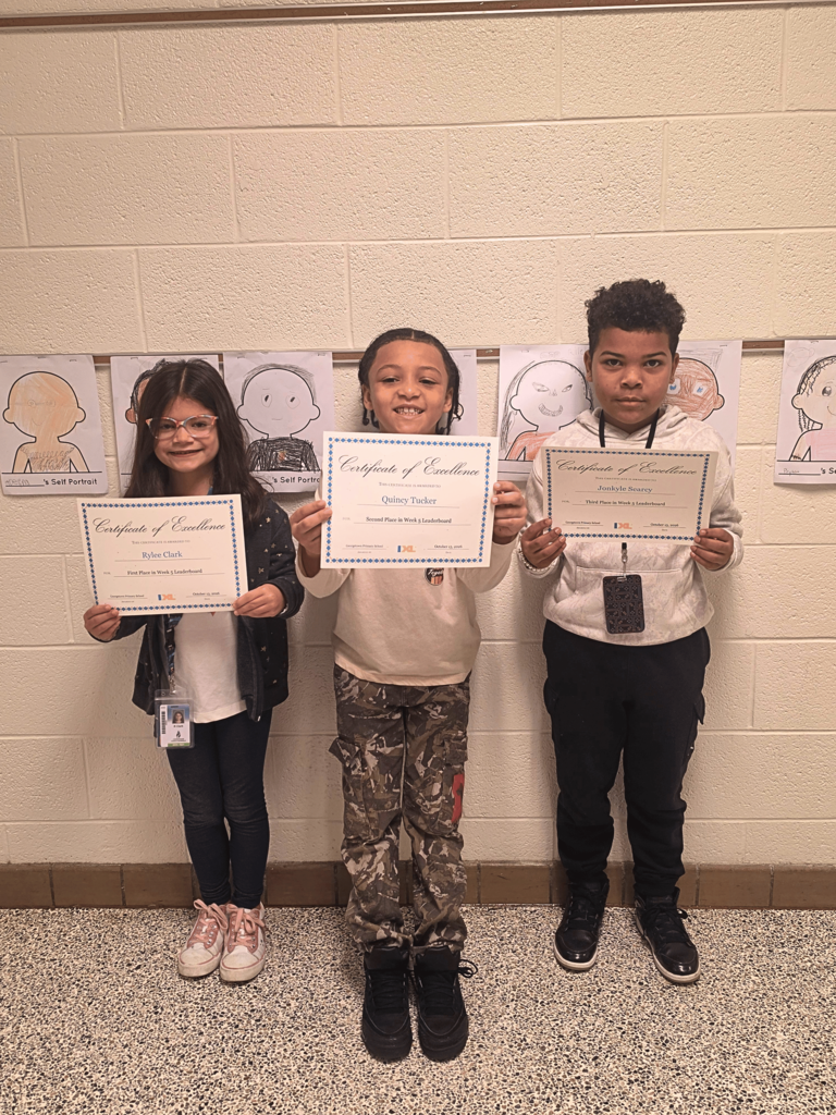 second grade IXL leaderboard winners stand side by side with their achievement certificates