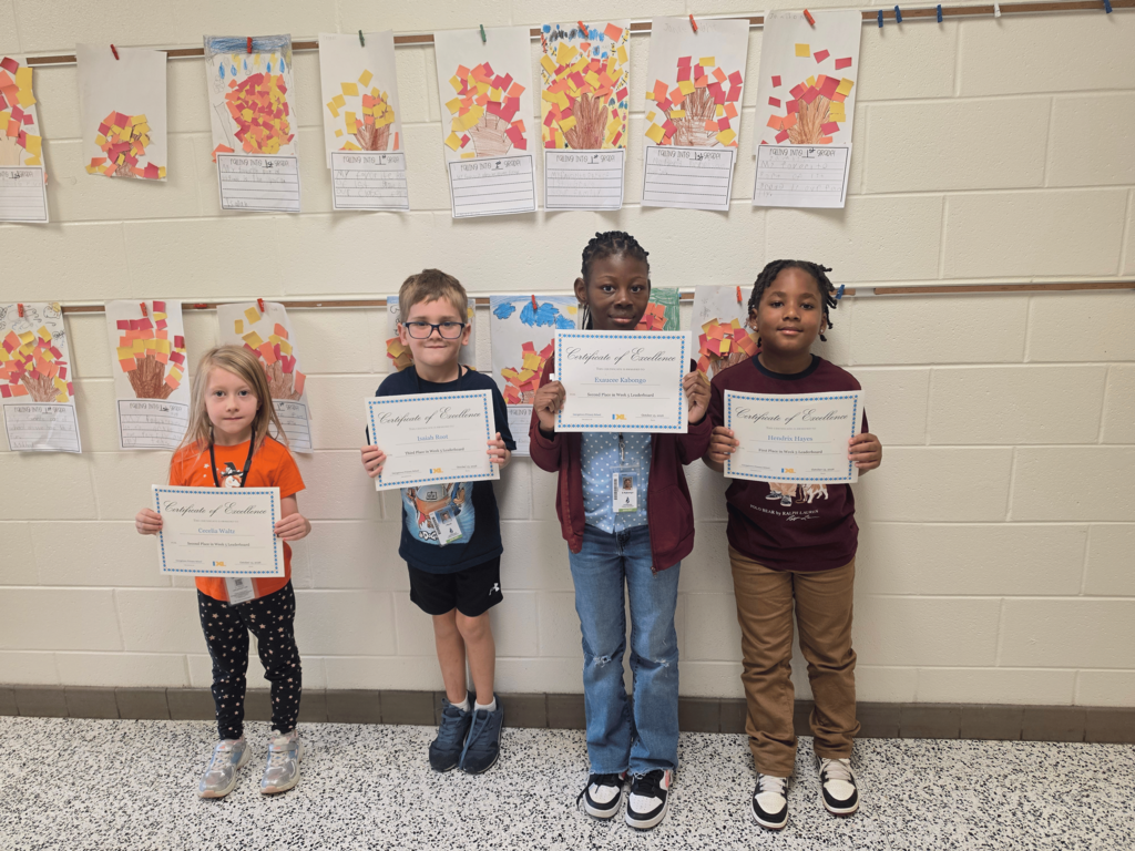 first grade IXL leaderboard winners stand side by side with their achievement certificates