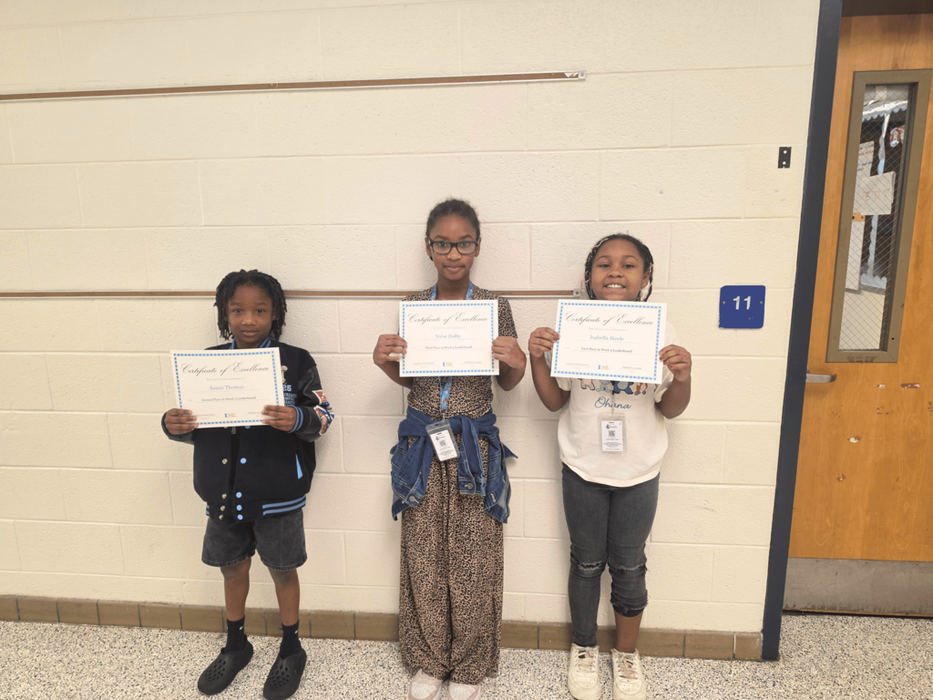third grade IXL leaderboard winners stand side by side with their achievement certificates