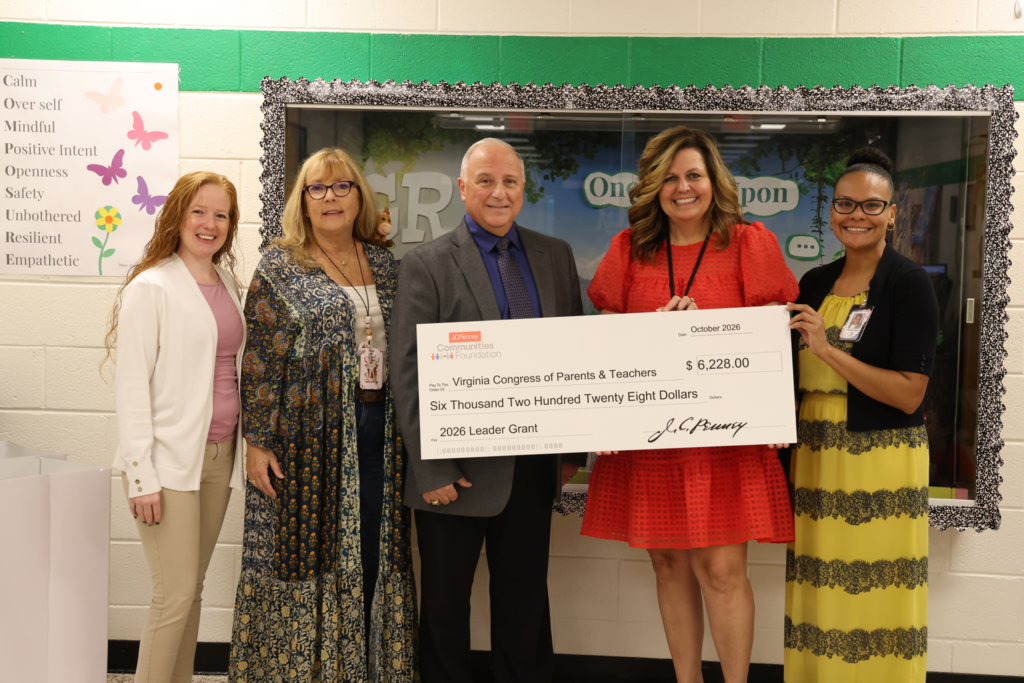 Executive passes over check to GRP