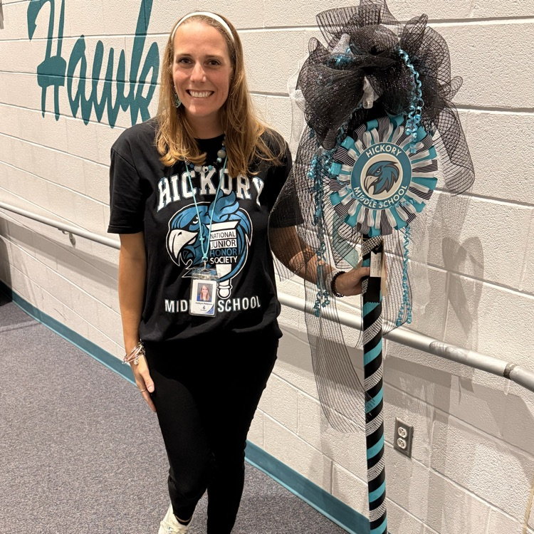 one of our teachers happily holding the spirit stick
