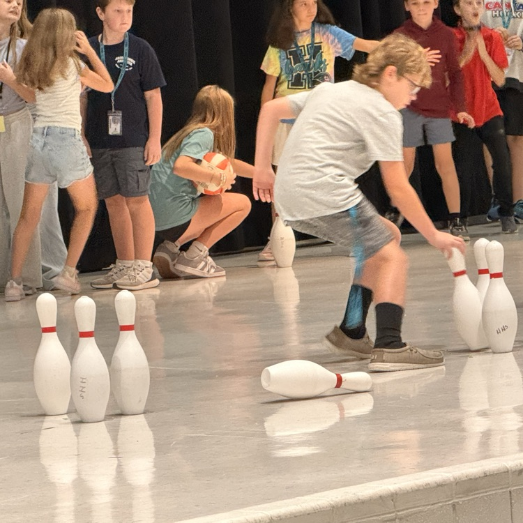 students racing to put up their pins