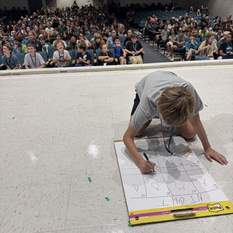 student competing while crowd looks on