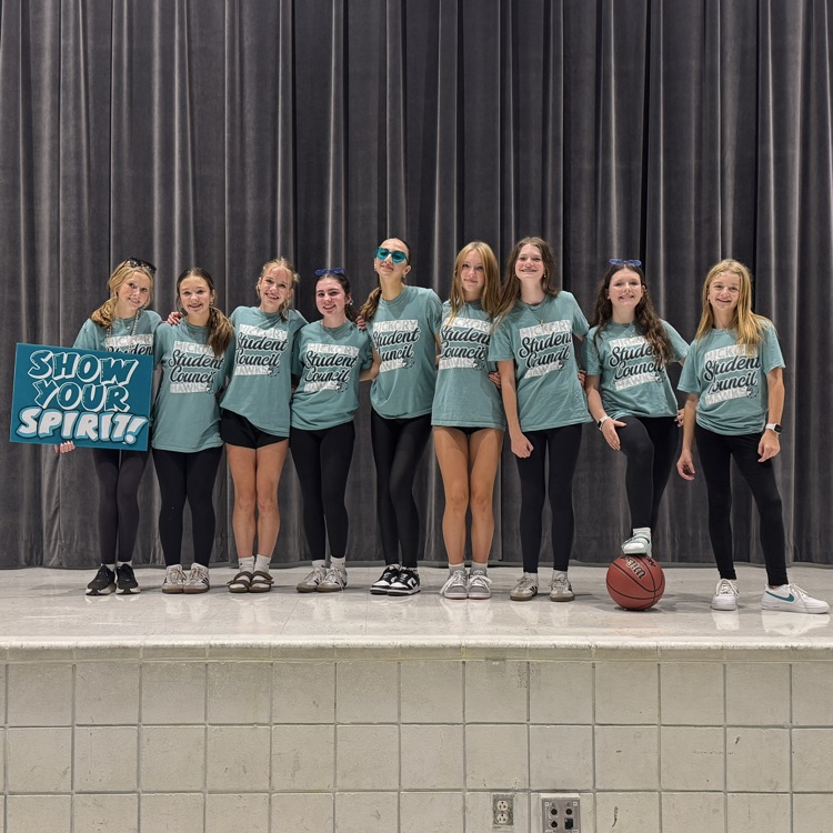 student leaders who led the pep rally standing proudly on stage