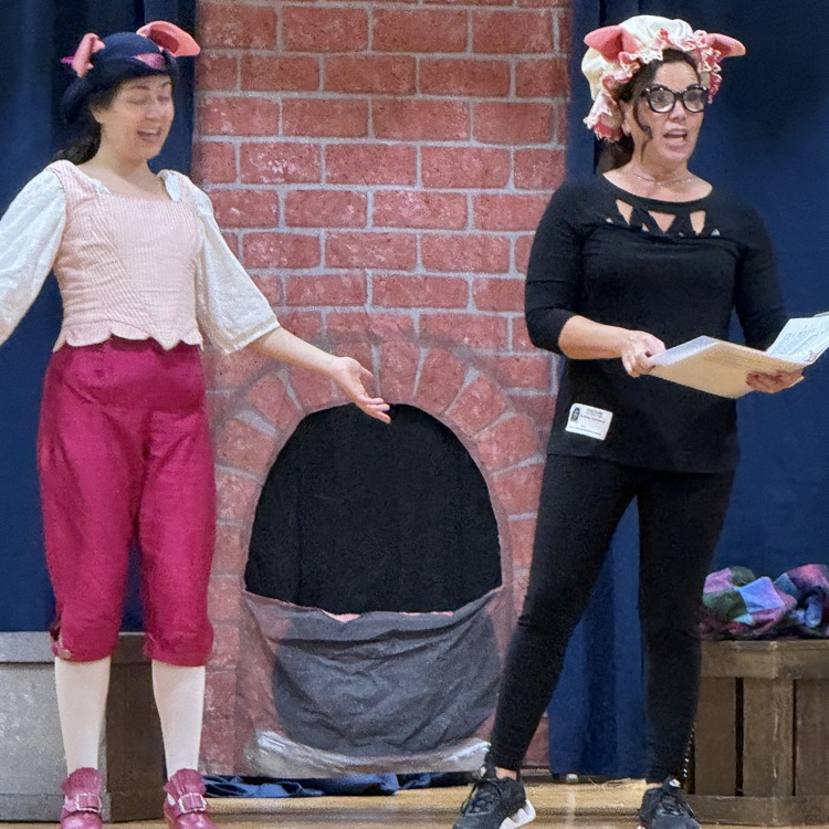 two performers dressed as two little pigs.