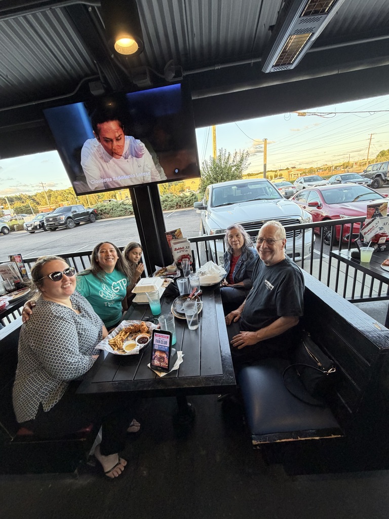 GTP family poses with dinner at Bubba's 33 for Dine to Donate night