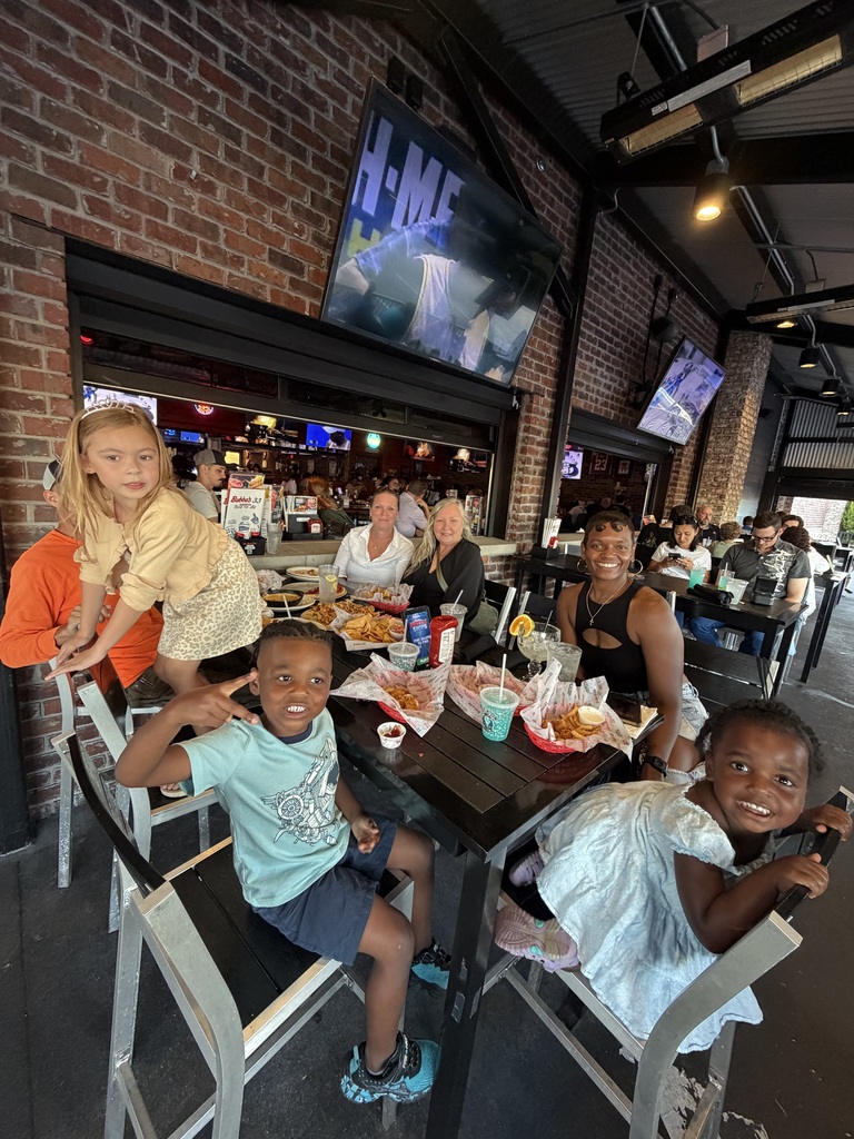 GTP family poses with dinner at Bubba's 33 for Dine to Donate night