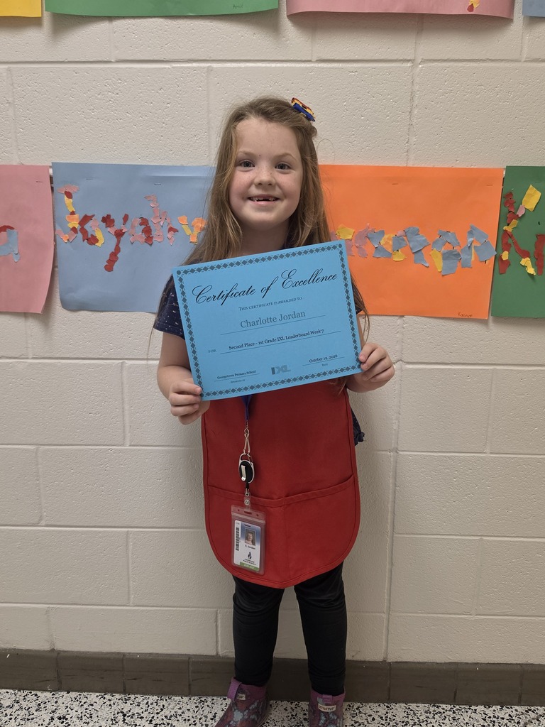 IXL Leaderboad second place winner for first grade poses with certificate
