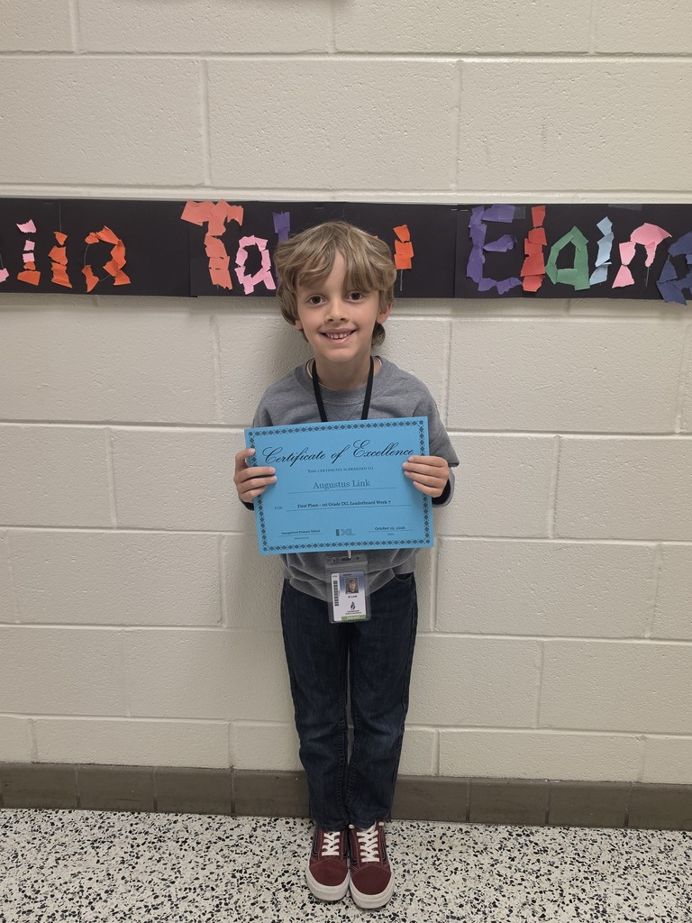 IXL Leaderboad first place winner for first grade poses with certificate