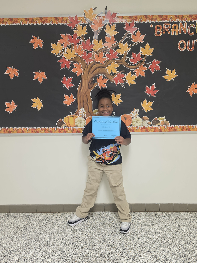 Third grade IXL Leaderboard winner poses  with his certicates