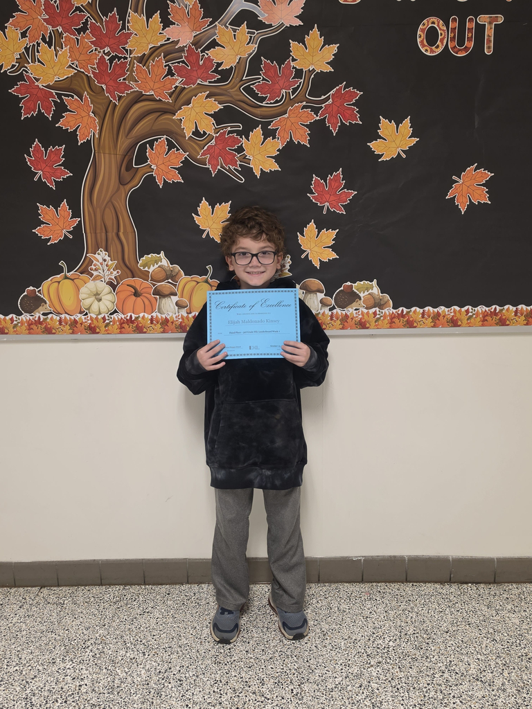 Third grade IXL Leaderboard winner poses  with his certicates