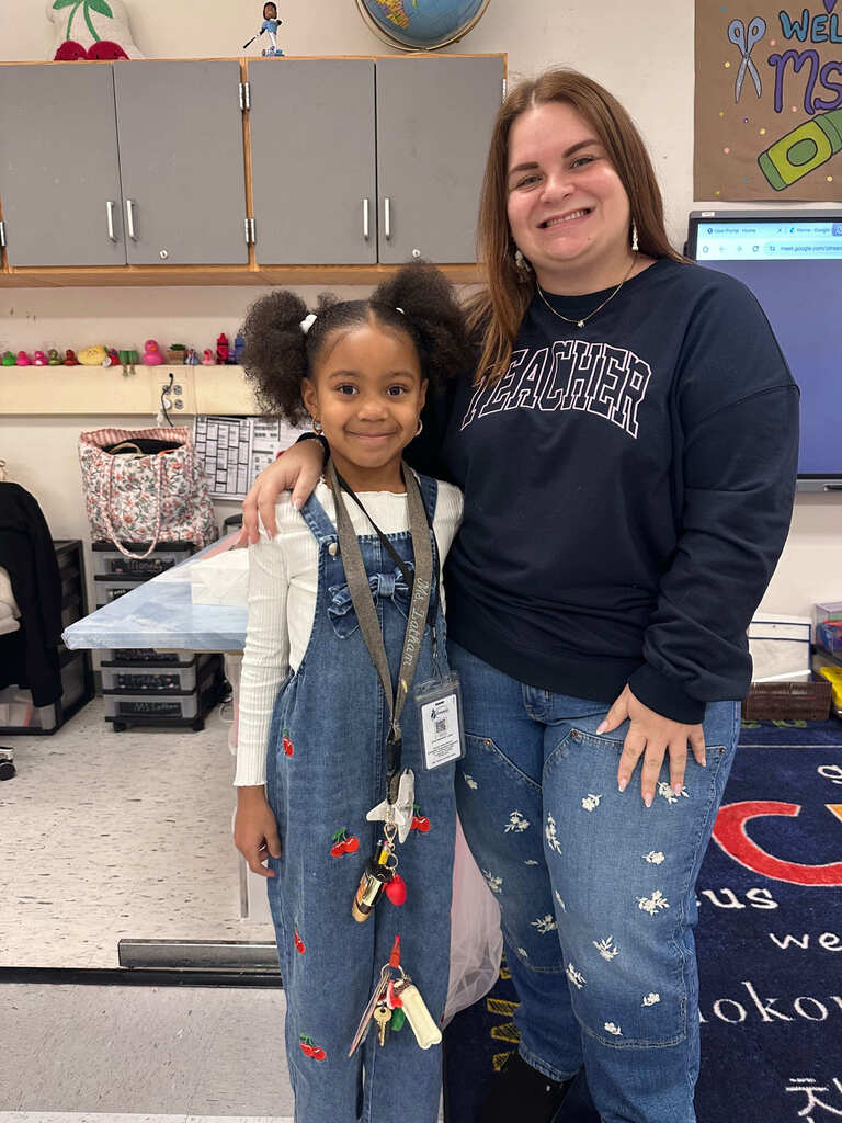student dressed as teacher for career day poses with her teacher