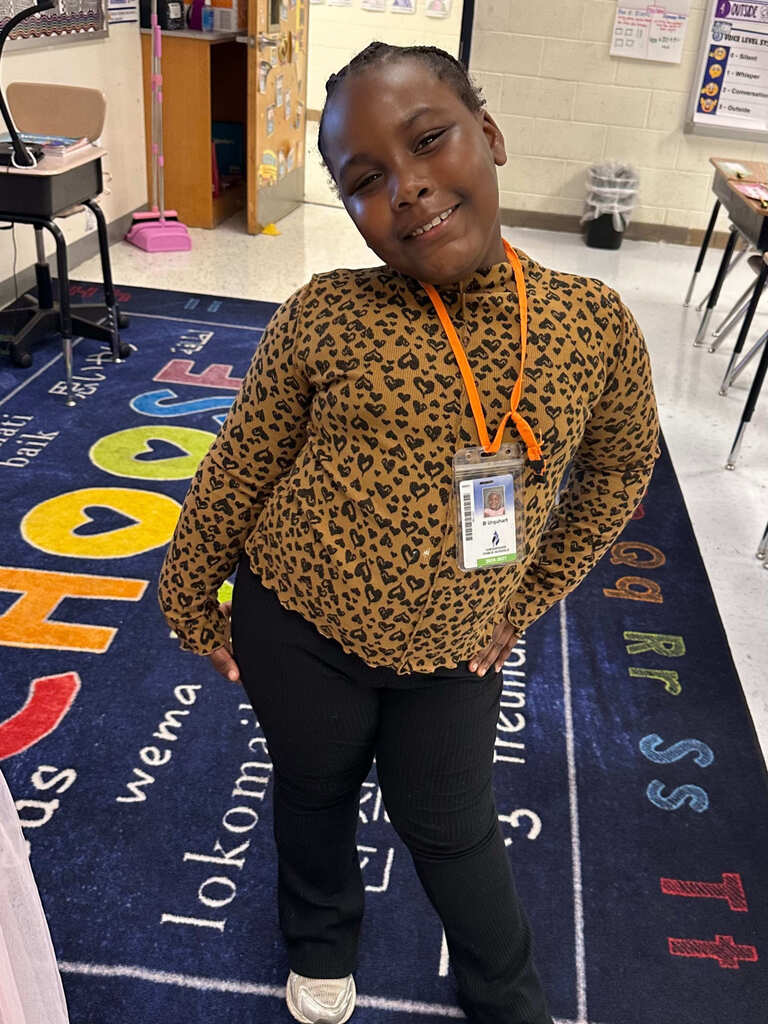 student strikes a model posed while dressed as a model for career day