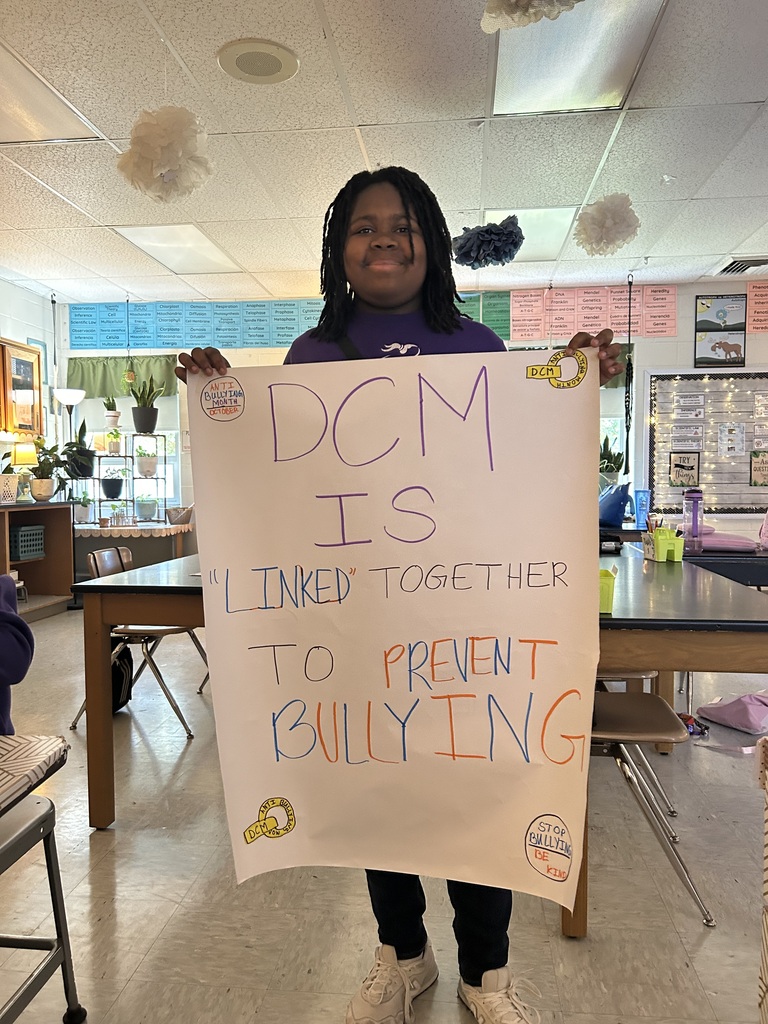 a student holding an anti bullying poster