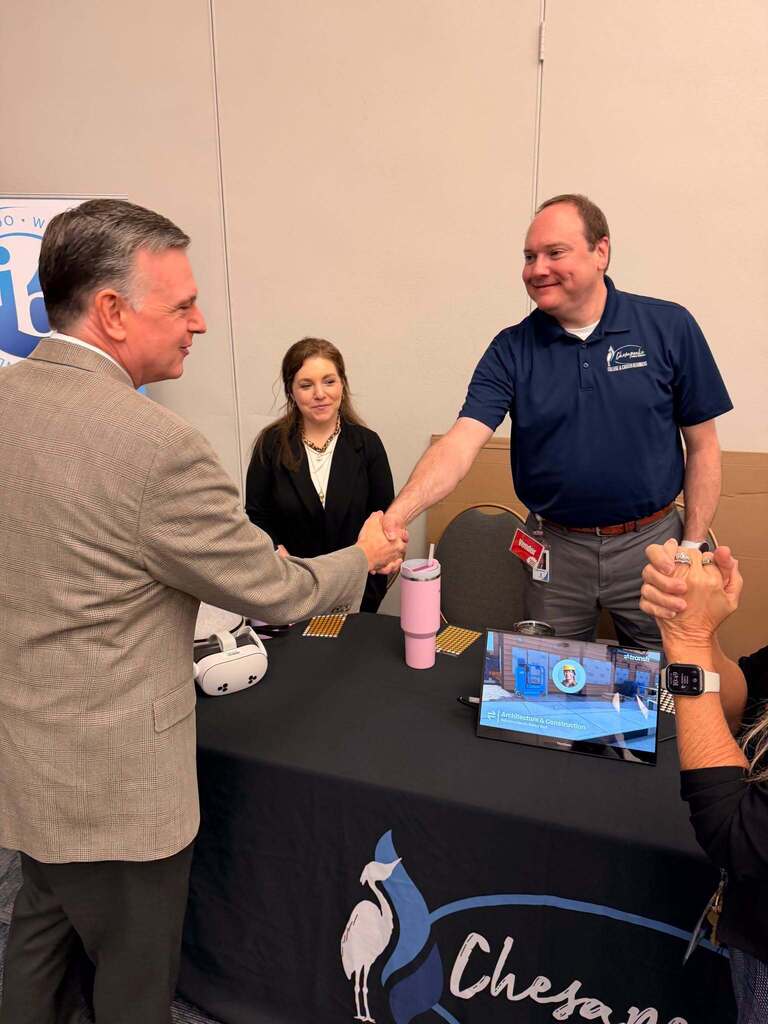 Dr. Brubaker shakes hands with employee