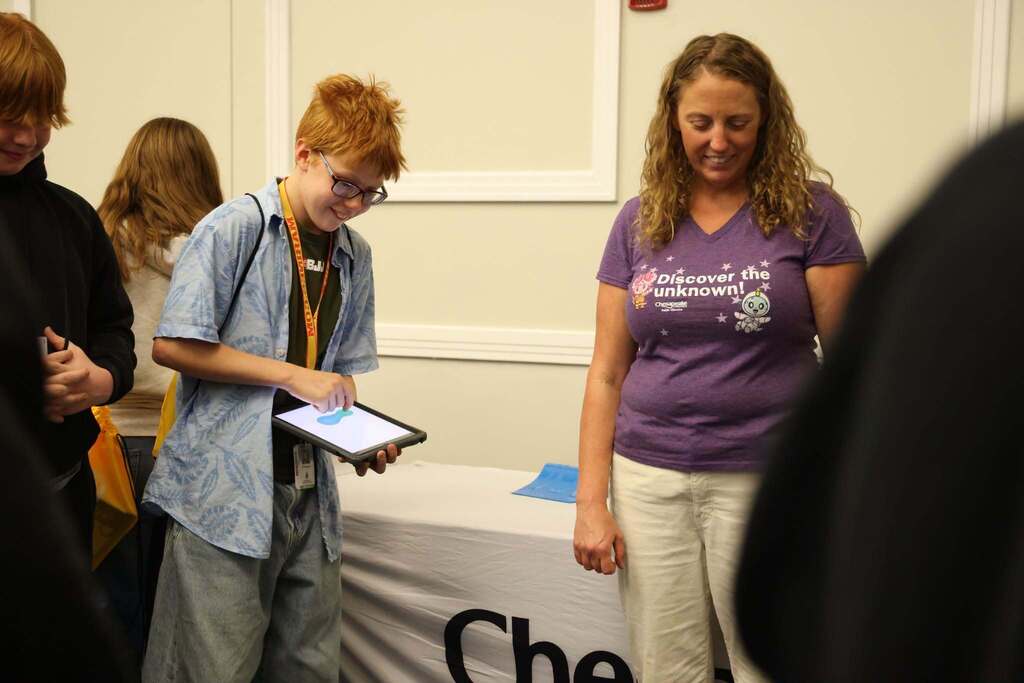 student uses ipad to work with bots