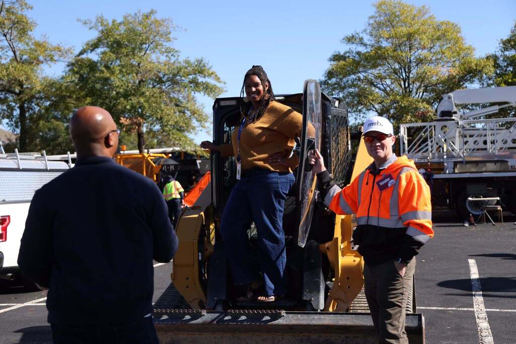 principal stands on tractor