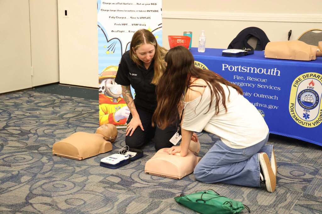 student practices CPR on a dummy