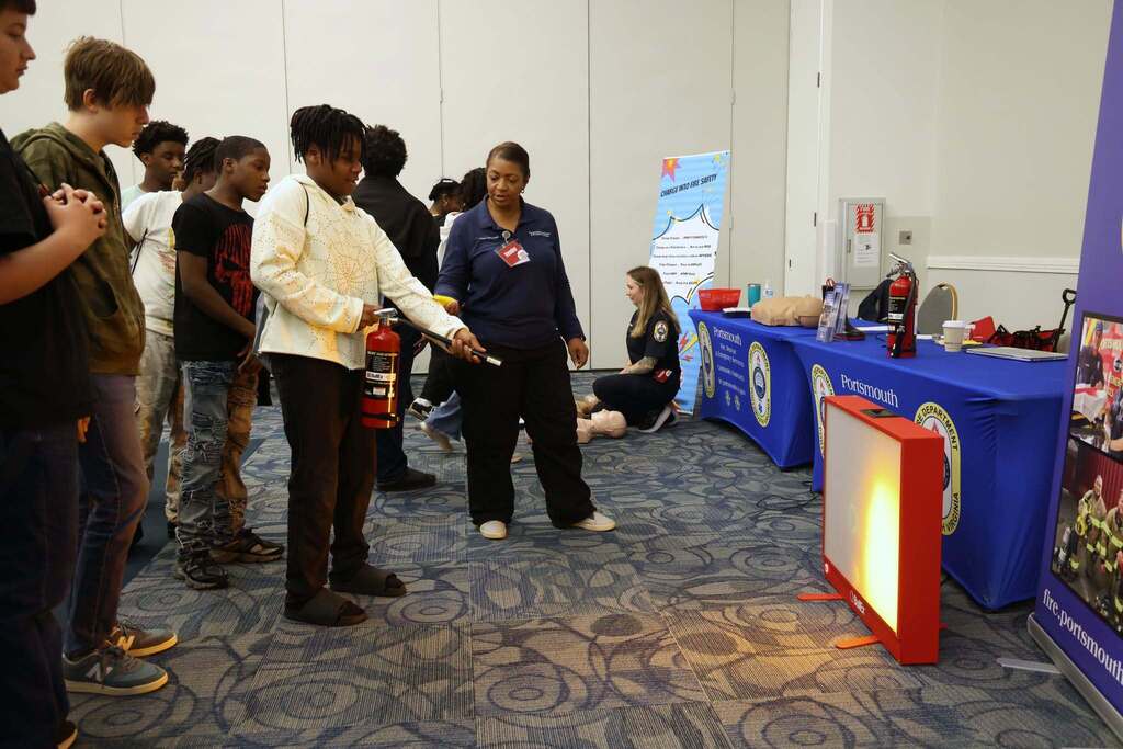 student practices using a fire extinguisher