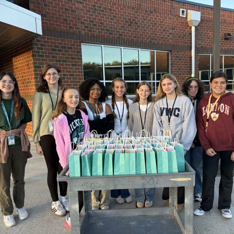 students smiling with gift bags for drivers