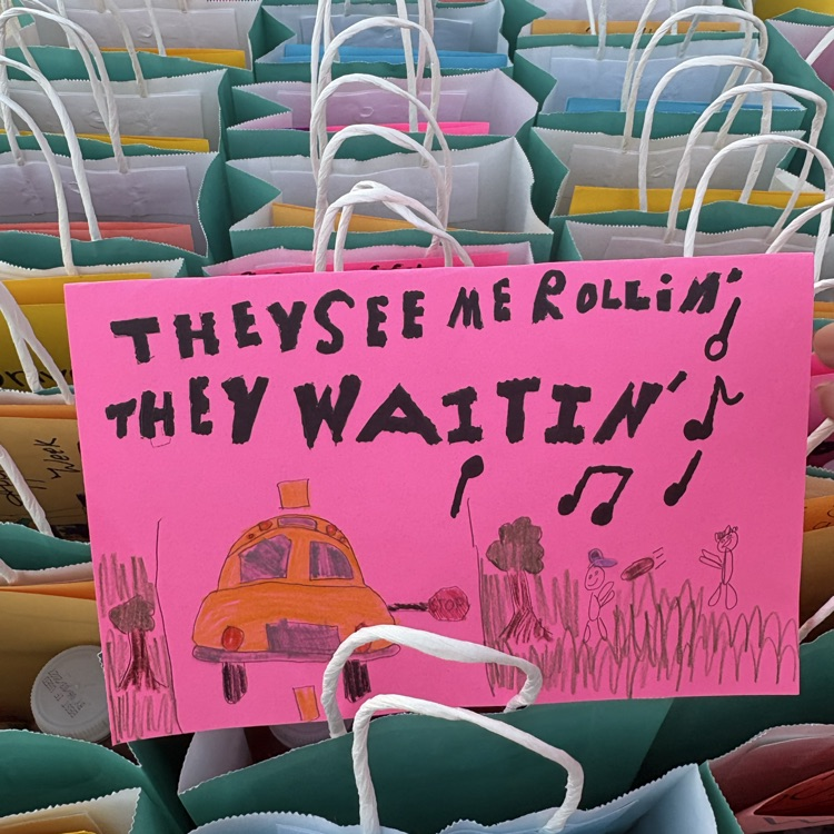 a sign decorated by a student with the gift bags