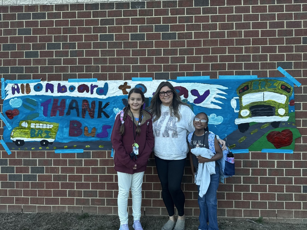 BRI students smiling with their school bus drivers in appreciation of School Bus Safety & Appreciation Week.