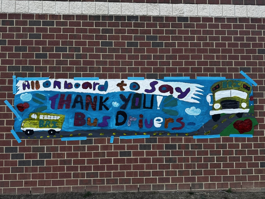BRI students smiling with their school bus drivers in appreciation of School Bus Safety & Appreciation Week.